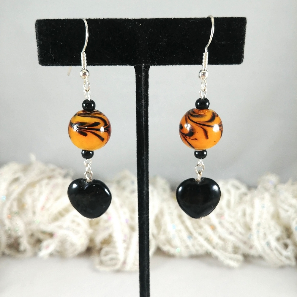 Glass bead earrings black heart tiger esque color